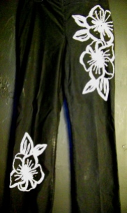 Black slacks with white embroidery.